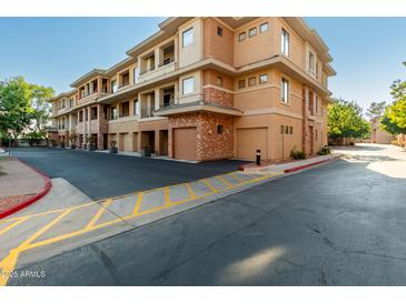 Exterior view of a modern building with attached garages and landscaping at 2989 N 44Th St # 1004, Phoenix, AZ 85018