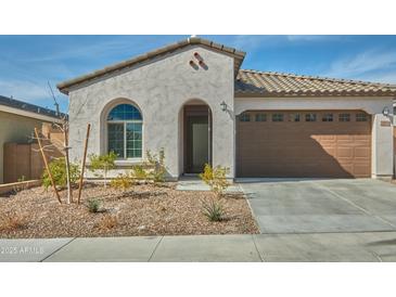 Charming single-story home featuring a tile roof, arched entry, and low-maintenance landscaping at 32034 N 125Th Ave, Peoria, AZ 85383