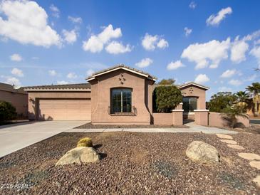 Single-story home with desert landscaping and a two-car garage at 42950 W Misty Morning Ln, Maricopa, AZ 85138