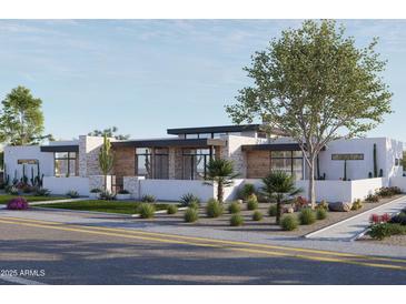 Contemporary home with wood and stone accents, and drought-tolerant landscaping at 8226 E Davenport Dr, Scottsdale, AZ 85260