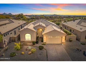 Stunning exterior elevation featuring desert landscaping and mountain views at sunset at 9523 E Sandy Vista Dr, Scottsdale, AZ 85262