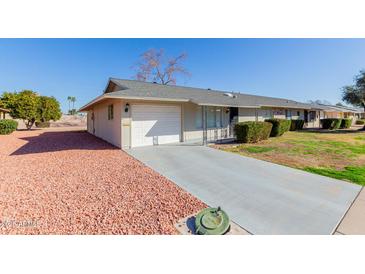 View of the home's exterior, showcasing the garage and landscaping at 10450 W Campana Dr, Sun City, AZ 85351