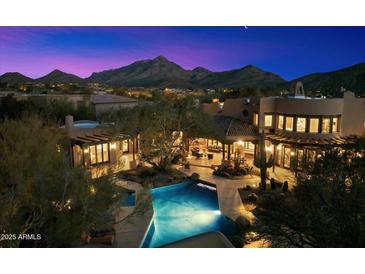 Stunning twilight aerial view of the estate with a backyard pool and mountain views at 10801 E Happy Valley Rd # 102, Scottsdale, AZ 85255