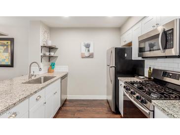 Modern galley kitchen features granite countertops and stainless steel appliances at 1505 N Center St # 119, Mesa, AZ 85201