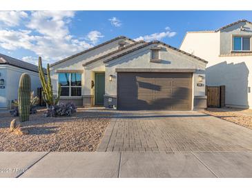 Single-story home with desert landscaping and a two-car garage at 2038 E Dry Wood Rd, Phoenix, AZ 85024