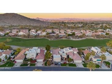 Stunning aerial view of the community with well-manicured landscaping and mountain views at 4636 E Monte Way, Phoenix, AZ 85044