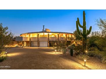 Stunning circular home with desert landscaping, at dusk at 7915 E Primrose Path, Carefree, AZ 85377
