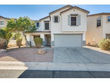 Two-story home featuring a neutral color scheme and a two-car garage, offering a modern and inviting curb appeal at 1081 E Lowell Ct, Gilbert, AZ 85295