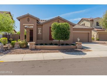 Inviting single-story home featuring a well-maintained front yard and two-car garage at 12541 W Miner Trl, Peoria, AZ 85383