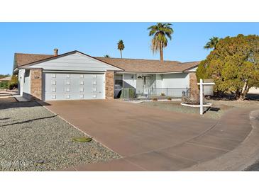 House exterior featuring a two-car garage and a well-maintained front yard at 16828 N 107Th Dr, Sun City, AZ 85351