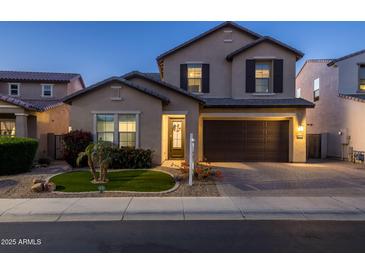 Two-story home with a brown garage door and landscaping at 18402 N 65Th Pl, Phoenix, AZ 85054
