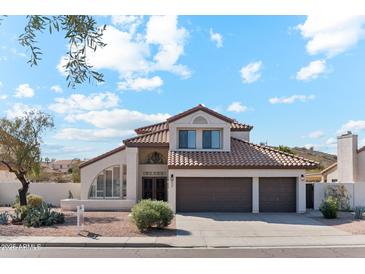 Two-story house with tile roof, two-car garage, and desert landscaping at 3435 E Desert Trumpet Rd, Phoenix, AZ 85044