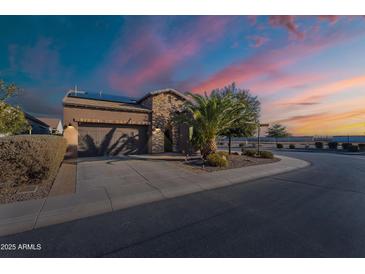 Charming stucco and brick home with desert landscaping, solar panels, and an attached two-car garage at 1808 E Crocus Ave, Queen Creek, AZ 85140