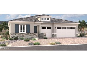 Charming single-story home with a stone facade, two-car garage, and professionally landscaped front yard at 18186 W Ashley Dr, Goodyear, AZ 85338