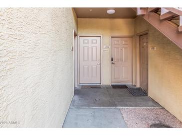 Condo entrance featuring unit numbers and stairwell at 18416 N Cave Creek Rd # 1057, Phoenix, AZ 85032