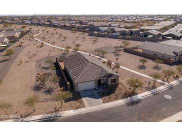 A lovely home features a two-car garage and well-maintained landscaping in a peaceful community at 34395 N Cherrystone Dr, San Tan Valley, AZ 85144