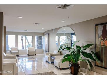 Inviting lobby area with tile floors, comfortable white seating, and ample natural light from large windows at 5450 E Deer Valley Dr # 2193, Phoenix, AZ 85054