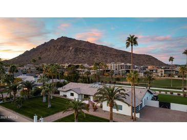 Aerial view of a single-story home with mountain views and palm trees at 6302 E Hillcrest Blvd, Scottsdale, AZ 85251