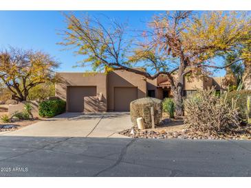 Charming home with a two-car garage and desert landscaping in a sunny neighborhood at 9200 E Whitethorn Cir # 601, Scottsdale, AZ 85266