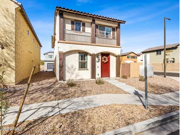 Charming two-story home with a red door, a balcony and low-maintenance landscaping at 11434 W St John Rd, Surprise, AZ 85378