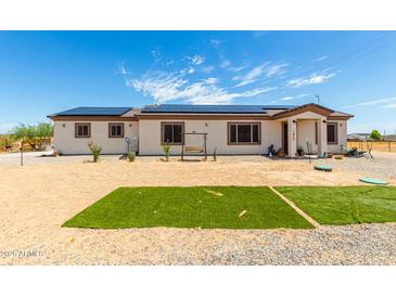 Charming single-story home with solar panels and desert landscaping at 1415 N 357Th Ave, Tonopah, AZ 85354