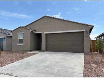Charming single-story home with a two-car garage and low-maintenance desert landscaping at 17449 W Eva St, Waddell, AZ 85355
