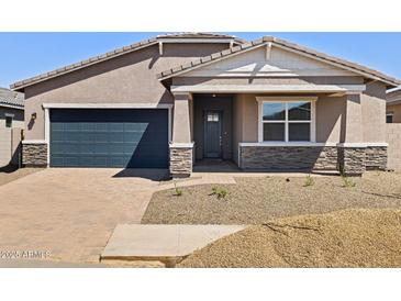 Inviting single-Gathering home boasts a stylish facade and a two-car garage in a well-maintained neighborhood at 17624 W Pierson St, Goodyear, AZ 85395