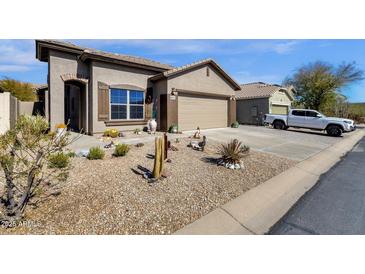 Charming front yard featuring desert landscaping, gravel, and a two car garage at 18434 E El Buho Pequeno Rd, Gold Canyon, AZ 85118