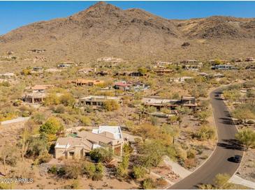 Expansive desert community with luxury homes nestled against a mountain backdrop and winding roads at 5830 E Restin Rd, Carefree, AZ 85377
