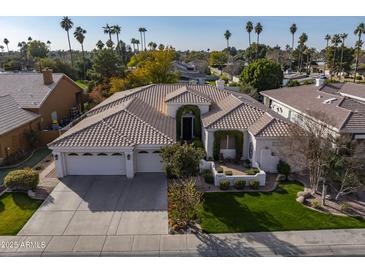 Charming, single-story home boasts a manicured lawn, beautiful desert landscaping, and a three-car garage at 6302 N 4Th Dr, Phoenix, AZ 85013