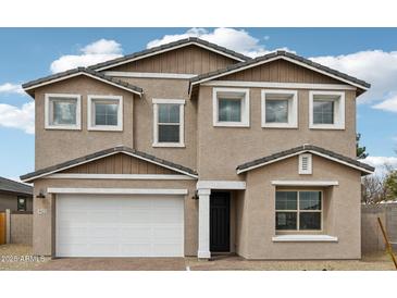 Charming two-story home features a stucco exterior, a two-car garage, and a well-maintained lawn at 9522 W Luxton Ln, Tolleson, AZ 85353