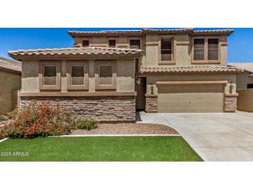 Charming two-story home featuring a neutral color scheme, stone accents, and a well-maintained lawn at 11728 W Villa Hermosa N Ln, Sun City, AZ 85373