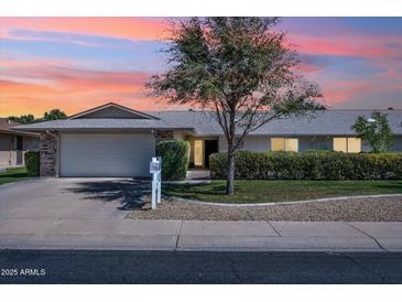 Charming single-story home with a well-manicured lawn and attached garage, perfect for suburban living at 12814 W Shadow Hills Dr, Sun City West, AZ 85375