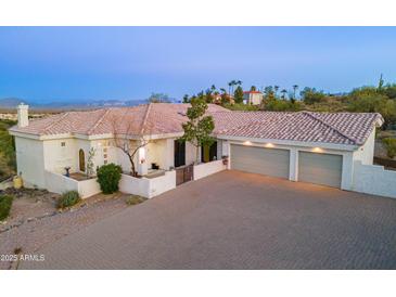 Beautiful desert home featuring a three-car garage and a spacious brick driveway at 16141 E Thistle Dr, Fountain Hills, AZ 85268