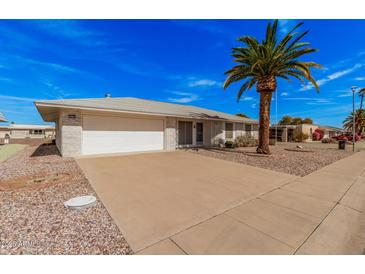 Charming single-story home featuring a well-maintained front yard, desert landscaping, and attached two-car garage at 10330 W Gulf Hills Dr, Sun City, AZ 85351