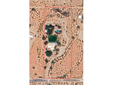 Aerial view of property in desert setting featuring a large pool and private pond at 15076 W Belmont Dr, Casa Grande, AZ 85194