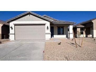 Charming single-story home featuring a two-car garage, gravel landscaping, and neutral color palette at 23252 W Miami St, Buckeye, AZ 85326