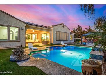 Backyard pool featuring pavers, lounge chairs, and a covered patio connected to the main house at 3005 E Valencia Dr, Phoenix, AZ 85042