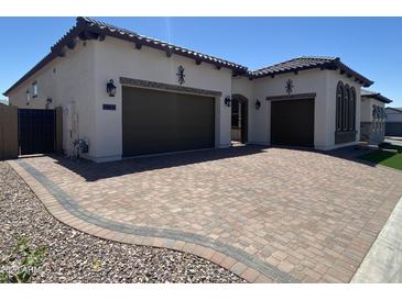 Beautiful single-story home boasts a paver driveway, two-car garage, and well-manicured landscaping at 5741 E Star Valley St, Mesa, AZ 85215