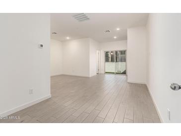 Bright living room with neutral paint, recessed lighting, tile floor, and sliding glass doors at 8255 N 22Nd Dr, Phoenix, AZ 85021