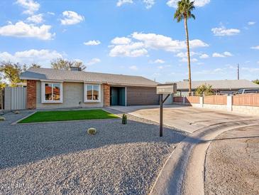 Charming single story home with low maintenance desert landscaping and a private drive at 10619 W Sells Dr, Phoenix, AZ 85037