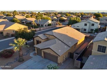 This is an aerial view of a two-story home in a residential neighborhood with mountain views at 1619 E Beretta Pl, Chandler, AZ 85286
