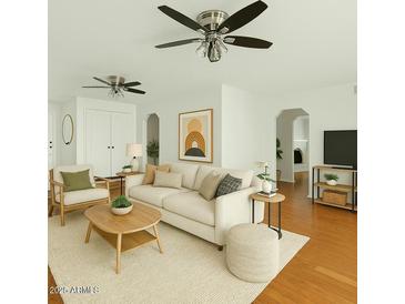 Bright living room featuring hardwood floors, neutral paint, and modern ceiling fans at 307 W Alamo Dr, Chandler, AZ 85225
