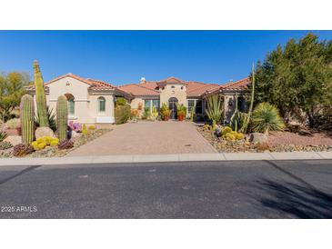 Inviting home featuring desert landscaping, a circular driveway, and a red tile roof at 37267 Ne Greythorn Cir, Carefree, AZ 85377