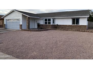 Charming single-story home featuring a no grass front yard and stylish exterior stone accents at 3728 E Grove Ave, Mesa, AZ 85206