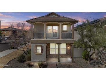 Two-story home with a covered front porch and balcony showcasing great natural light at 12343 W Essig Way, Peoria, AZ 85383