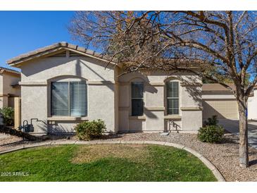 Charming single-story home with manicured lawn, desert landscaping, and a light beige exterior at 2132 N Holguin Way, Chandler, AZ 85225