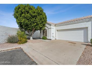 Charming single-story home with a two-car garage, desert landscaping and mature shade tree at 320 S 70Th St # 54, Mesa, AZ 85208