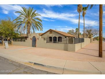 Charming home featuring desert landscaping, privacy wall and entry gate at 418 E 3Rd St, Casa Grande, AZ 85122