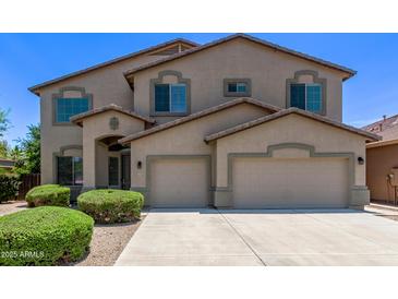 Charming two-story home featuring a three-car garage and well-maintained front landscaping at 42735 W Bravo Dr, Maricopa, AZ 85138